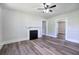 Light-filled living room featuring hardwood flooring, a classic fireplace, and neutral wall paint at 899 Marshall Fuller Rd, Dallas, GA 30157