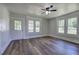 Bright living room featuring hardwood floors and lots of natural light from the large windows and white trim at 899 Marshall Fuller Rd, Dallas, GA 30157