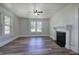 Cozy living room with a fireplace, hardwood floors and large windows at 899 Marshall Fuller Rd, Dallas, GA 30157