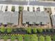 Aerial view of townhome roofs, landscaping, and parking area in neighborhood at 130 Maple Creek Way, Woodstock, GA 30188