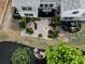 Aerial view of a backyard with a patio, landscaping, and green grass at 130 Maple Creek Way, Woodstock, GA 30188