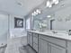 Bright bathroom with double sinks, decorative tile flooring, and a separate soaking tub at 130 Maple Creek Way, Woodstock, GA 30188