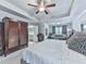 Spacious bedroom featuring a ceiling fan, seating area, and ensuite bathroom for comfortable living at 130 Maple Creek Way, Woodstock, GA 30188