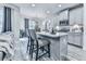 Modern kitchen featuring white cabinets, stainless steel appliances, a central island with seating, and stylish pendant lighting at 130 Maple Creek Way, Woodstock, GA 30188