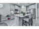 Open kitchen with island, stainless steel appliances, gray cabinetry, and modern finishes at 130 Maple Creek Way, Woodstock, GA 30188