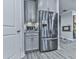 Kitchen area showcases a stainless-steel refrigerator and gray cabinets with modern design elements at 130 Maple Creek Way, Woodstock, GA 30188