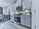 Well-equipped kitchen featuring stainless steel appliances, modern grey cabinets, and stylish countertops at 130 Maple Creek Way, Woodstock, GA 30188