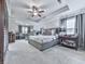 Spacious main bedroom featuring a sitting area, tray ceiling, and elegant decor for ultimate relaxation at 130 Maple Creek Way, Woodstock, GA 30188