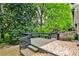 Overlooking the yard, a wooden deck features built-in bench seating and access to a tiled patio at 2302 Colonial Ne Dr, Brookhaven, GA 30319