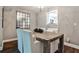 Cozy dining area features rustic table, modern light fixture and views to kitchen at 2302 Colonial Ne Dr, Brookhaven, GA 30319