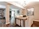 Dining room features a rustic table, modern light fixture, and views into living area at 2302 Colonial Ne Dr, Brookhaven, GA 30319