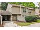 Inviting townhome features neutral siding, stone accents, and a convenient carport at 2302 Colonial Ne Dr, Brookhaven, GA 30319