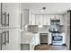 Modern kitchen features stainless appliances, subway tile backsplash, and white cabinets at 2302 Colonial Ne Dr, Brookhaven, GA 30319