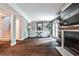 Spacious living room featuring modern fireplace, hardwood floors, and french doors at 2302 Colonial Ne Dr, Brookhaven, GA 30319