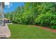 Green backyard features a lush lawn, patio area, and mature trees, offering privacy at 4240 Spring Ridge Dr, Cumming, GA 30028