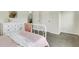 Bright bedroom featuring a white iron bed frame, floral dresser, and plush grey carpeting at 4240 Spring Rdg, Cumming, GA 30028