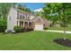 Charming two-story home with brick accents, a well-manicured lawn, and mature landscaping at 4240 Spring Rdg, Cumming, GA 30028