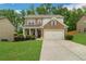 Charming two-story brick home with a well-manicured lawn and inviting curb appeal at 4240 Spring Ridge Dr, Cumming, GA 30028