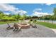 Outdoor fire pit with seating area surrounded by Adirondack chairs, pea gravel, and lush landscaping near the pool at 4240 Spring Ridge Dr, Cumming, GA 30028
