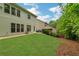 Expansive backyard with a manicured lawn, mature trees, and a peaceful setting, perfect for recreation at 4240 Spring Ridge Dr, Cumming, GA 30028