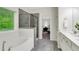 Bright bathroom with a tub, shower, and double vanity at 4240 Spring Ridge Dr, Cumming, GA 30028