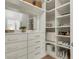 Custom closet with drawers, shelving, and a mirror at 4240 Spring Ridge Dr, Cumming, GA 30028