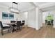 Elegant dining room featuring modern lighting, stylish decor, and a view into another dining space at 4240 Spring Ridge Dr, Cumming, GA 30028