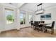 Bright dining room with natural light, modern light fixture, and view of front yard at 4240 Spring Ridge Dr, Cumming, GA 30028