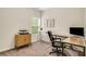 Well-lit home office with a large desk setup, stylish cabinet, and view to the outdoors at 4240 Spring Ridge Dr, Cumming, GA 30028