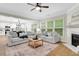 Bright and open living space with fireplace, seamlessly connected to a modern kitchen and dining area at 4240 Spring Ridge Dr, Cumming, GA 30028