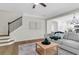 Comfortable living room featuring a modern staircase and an opening to the kitchen and dining areas at 4240 Spring Ridge Dr, Cumming, GA 30028