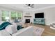 Comfortable living room with fireplace and modern furnishings, filled with natural light at 4240 Spring Ridge Dr, Cumming, GA 30028