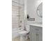 Bathroom featuring white subway tile shower, gray vanity, and a round mirror at 4370 Freys Farm Nw Ln, Kennesaw, GA 30152