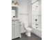 Bathroom featuring a white tiled shower and grey vanity and flooring at 4370 Freys Farm Nw Ln, Kennesaw, GA 30152