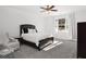 Bedroom featuring a window, neutral walls, a ceiling fan, carpet, and a large bed at 4370 Freys Farm Nw Ln, Kennesaw, GA 30152