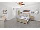 Bedroom featuring a surfboard decor, neutral walls, a ceiling fan, carpet, and a full size bed at 4370 Freys Farm Nw Ln, Kennesaw, GA 30152
