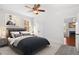 Comfortable bedroom featuring a queen-sized bed, a ceiling fan, and access to the living room at 4370 Freys Farm Nw Ln, Kennesaw, GA 30152