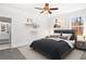 Comfortable bedroom featuring a queen-sized bed, a ceiling fan, and decorative shelving at 4370 Freys Farm Nw Ln, Kennesaw, GA 30152