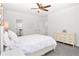 Bright bedroom with a ceiling fan and a white dresser with flowers at 4370 Freys Farm Nw Ln, Kennesaw, GA 30152