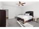 Bedroom featuring neutral walls, a ceiling fan, carpet, and a large bed at 4370 Freys Farm Nw Ln, Kennesaw, GA 30152