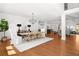 Open-concept dining area with hardwood floors, a large dining table, and a view of the living spaces at 4370 Freys Farm Nw Ln, Kennesaw, GA 30152