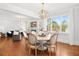 Bright dining room with a round table, modern chandelier, and large windows at 4370 Freys Farm Nw Ln, Kennesaw, GA 30152