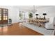 Bright dining room with hardwood floors, large windows, and an elegant chandelier above the table at 4370 Freys Farm Nw Ln, Kennesaw, GA 30152