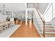 Grand foyer with hardwood floors, a staircase, an open dining area and views of a living area with stylish decor at 4370 Freys Farm Nw Ln, Kennesaw, GA 30152
