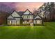 Handsome two-story home with manicured lawn, and a welcoming front porch framed by columns and lush landscaping at 4370 Freys Farm Nw Ln, Kennesaw, GA 30152