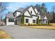 Charming two-story home with landscaped yard, grey brick facade, and a spacious driveway leading to a two-car garage at 4370 Freys Farm Nw Ln, Kennesaw, GA 30152