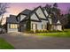 Beautiful grey two-story home featuring manicured landscaping and a spacious driveway leading to a two-car garage at 4370 Freys Farm Nw Ln, Kennesaw, GA 30152