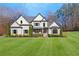 Inviting two-story home with a well-maintained lawn and a covered front entry offering a glimpse of the interior at 4370 Freys Farm Nw Ln, Kennesaw, GA 30152