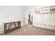 Inviting hallway with tile flooring, wooden accent table and mudroom at 4370 Freys Farm Nw Ln, Kennesaw, GA 30152