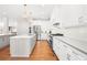 Gourmet kitchen with stainless steel appliances, double islands, hardwood floors, and a sleek design at 4370 Freys Farm Nw Ln, Kennesaw, GA 30152